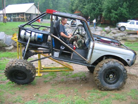 1992 Ford Mustang - Custom off-road buggy, likely a modified Ford Bronco, with a prominent roll cage and large tires.
