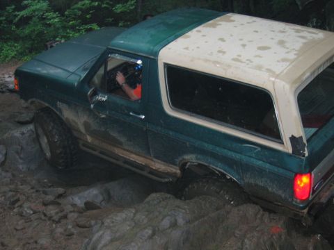 1992 Ford Mustang - This Ford Bronco is shown off-roading through a challenging rocky terrain.