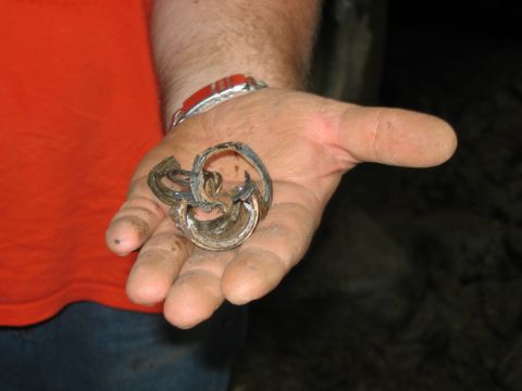1992 Ford Mustang - A close-up shows a damaged metal component held in a person's palm.