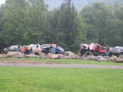 1979 Ford Bronco - Multiple off-road vehicles, including a 1978 Ford Bronco, navigate a challenging rocky obstacle course.