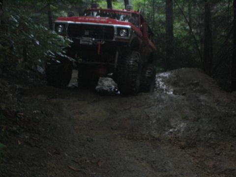 1979 Ford Bronco - This red 1979 Ford Bronco navigates a challenging muddy off-road course.