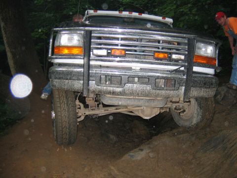 1992 Ford Mustang - A Ford F-Series truck navigates a rocky, off-road trail.
