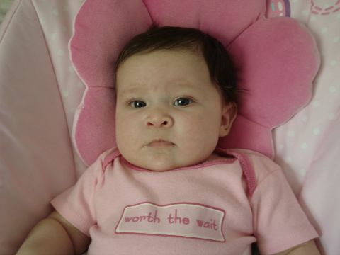 2000 Ford Crown Victoria - Baby in pink onesie with "worth the wait" text.