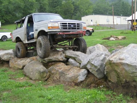 1995 Ford Bronco - A modified Ford Bronco navigates a rocky obstacle course.