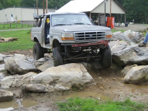 1995 Ford Bronco - A gray 1995 Ford Bronco is shown navigating a rocky obstacle course.