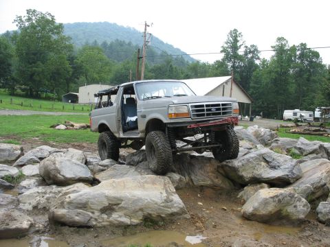 1995 Ford C-350 (Centurion Conversions) - Modified 1995 Ford C-350 (Centurion Conversions) navigates a challenging rocky terrain.