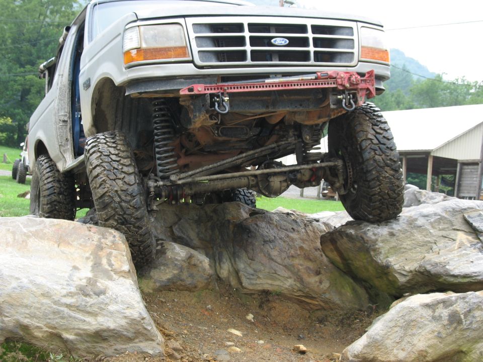 1995 Ford C-350 (Centurion Conversions) front end on rocks with Hi-Lift jack mounted