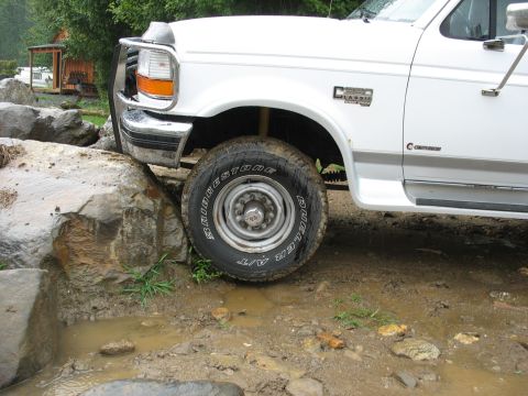 1995 Ford C-350 (Centurion Conversions) - White 1995 Ford C-350 (Centurion Conversions) navigates rocky terrain.