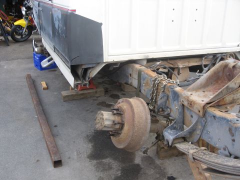 1990 Ford F-250 - The rear axle assembly is missing from this truck frame, which is elevated on blocks and jack stands.