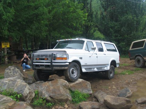 1995 Ford C-350 (Centurion Conversions) - White 1995 Ford C-350 (Centurion Conversions) navigates a rocky trail, with another vehicle visible in the background.
