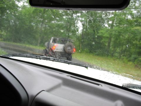 1995 Ford C-350 (Centurion Conversions) - View from inside a vehicle looking at another SUV driving in the rain.