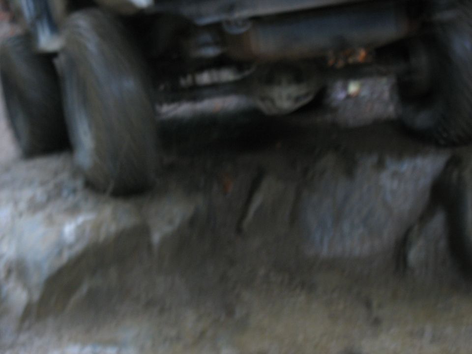 Muddy tires and undercarriage of a vehicle on a rough surface