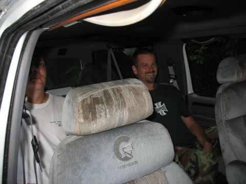 1995 Ford C-350 (Centurion Conversions) - Two people are seated inside a van, with a Centurion logo visible on a headrest.
