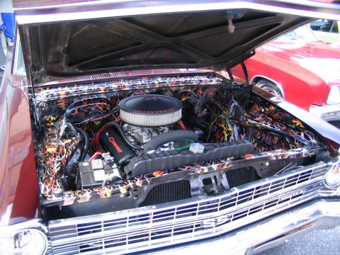 1993 Ford Taurus - Customized engine bay flame graphics and a Chevrolet air cleaner, with an SS emblem visible on the grille.