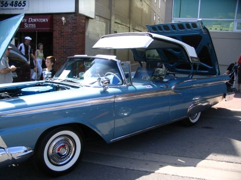 1993 Ford Taurus - A classic blue convertible is displayed with its hood and trunk open, its interior and engine bay.