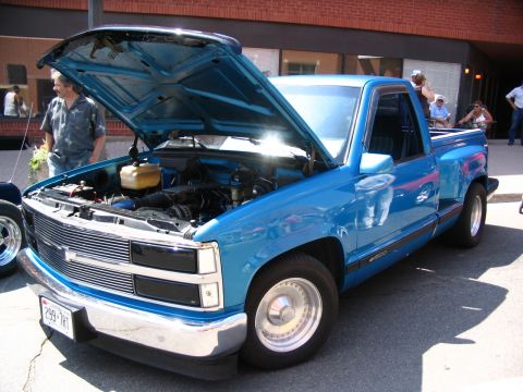 1993 Ford Taurus - A blue pickup truck is displayed with its hood open, revealing the engine compartment.