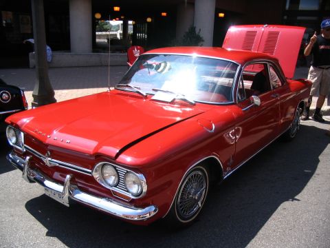 1993 Ford Taurus - Red classic coupe with hood and trunk open at a car show.