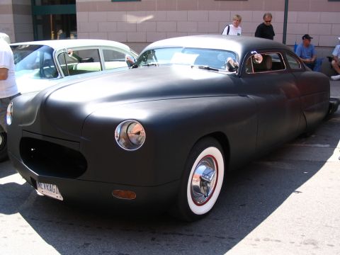 1993 Ford Taurus - A heavily customized matte black coupe with whitewall tires is displayed at the Telephone City Car Show 2007.
