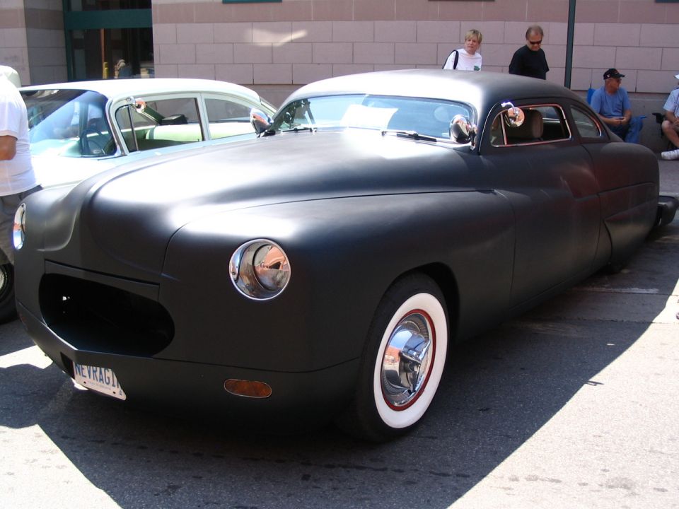 Matte black custom coupe with whitewall tires and a unique grille