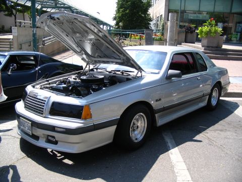 1993 Ford Taurus - A silver 1983 Ford Thunderbird coupe is displayed with its hood open, revealing the engine compartment.