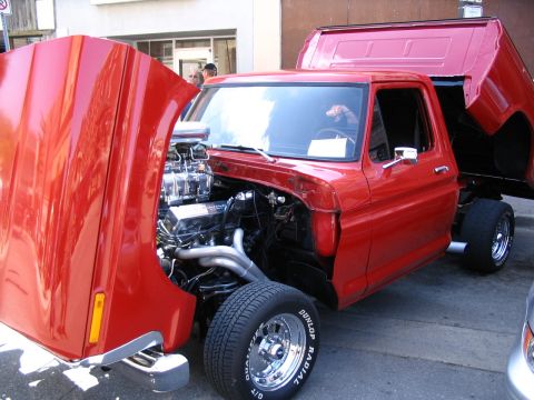 1993 Ford Taurus - This custom red pickup truck features a powerful engine with exposed chrome components and headers.