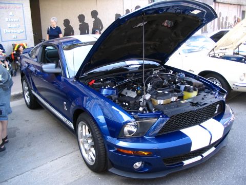 1993 Ford Taurus - Blue Ford Mustang GT500 at a car show, hood open to display the engine bay.