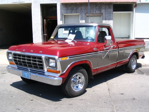1993 Ford Taurus - This red and silver Ford pickup truck has a distinctive grille and chrome accents.