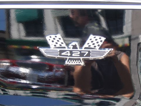 1993 Ford Taurus - A close-up of a car's '427' emblem, indicating a powerful engine, is visible against a dark, glossy background.