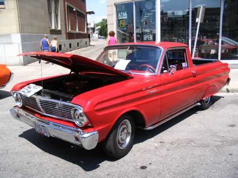 1993 Ford Taurus - A classic red pickup truck is displayed with its hood open, revealing the engine bay.