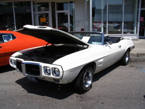 1993 Ford Taurus - White 1969 Pontiac Firebird convertible at a car show, hood open, revealing the engine bay.