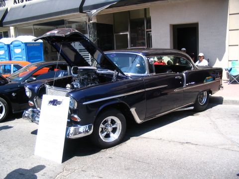 1993 Ford Taurus - Custom 1955 Chevrolet Bel Air on display at a car show, with its engine exposed.