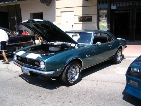 1993 Ford Taurus - A classic 1968 Chevrolet Camaro is displayed with its hood open, its engine bay.