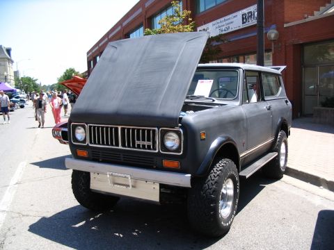 1993 Ford Taurus - Matte gray International Scout II SUV shown with its hood open at a car show.