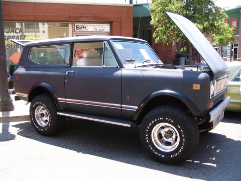 1993 Ford Taurus - This International Scout II is parked on a street with its hood up, showing off its engine bay.