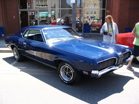 1993 Ford Taurus - A blue 1969 Mercury Cougar is displayed at a car show.