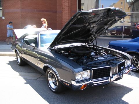 1993 Ford Taurus - 1970 Oldsmobile 442 on display at a car show, engine compartment visible.