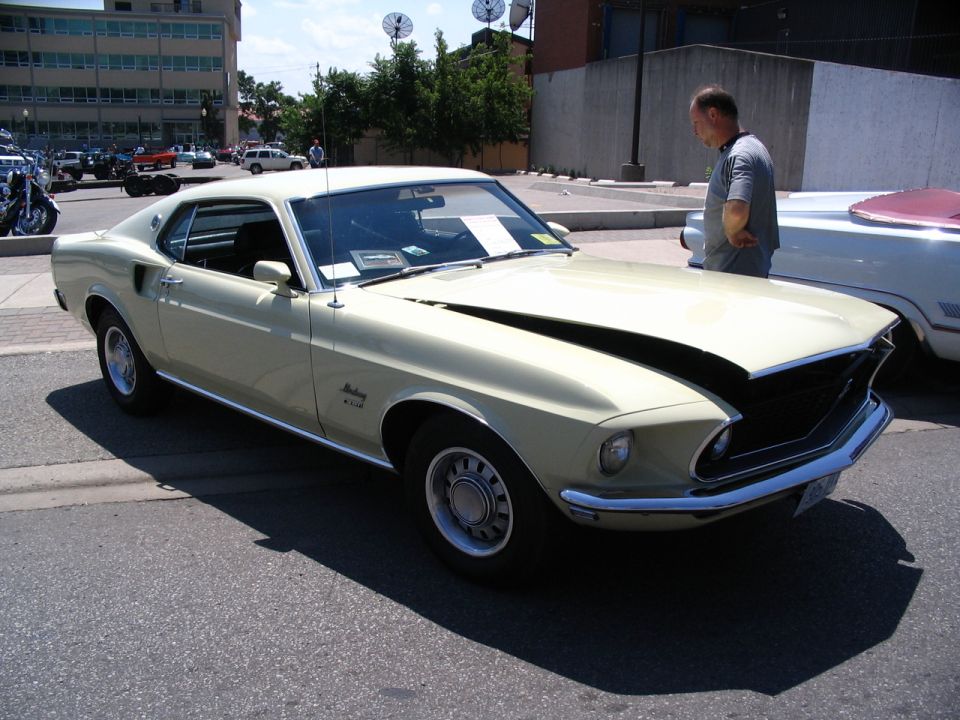 1969 Ford Mustang Mach 1 with hood open, parked on street