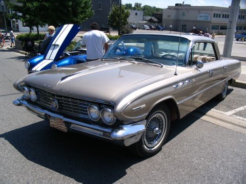 1993 Ford Taurus - A classic Buick LeSabre is parked on the street, with another car visible behind it.