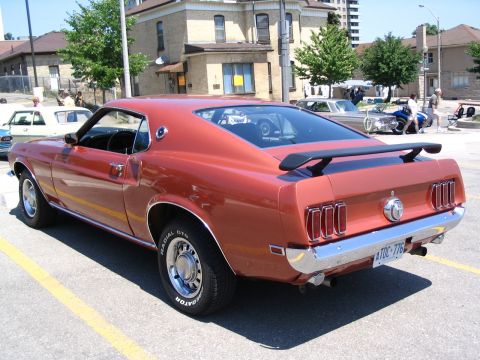 1993 Ford Taurus - This classic 1969 Ford Mustang is parked at an outdoor event.