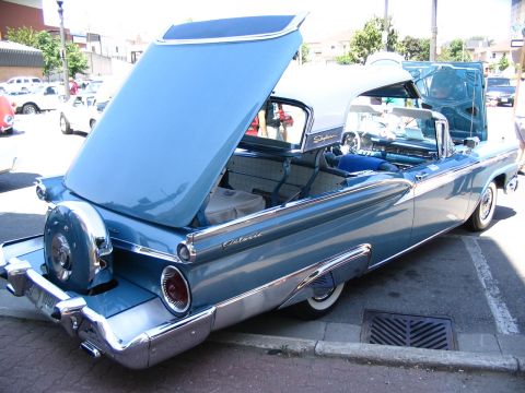 1993 Ford Taurus - A classic blue convertible, likely a 1959 model, is displayed with its hood and trunk open.