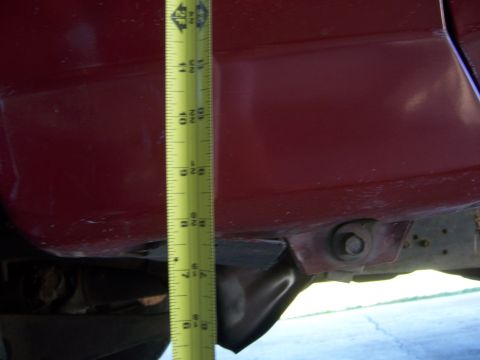 1991 Ford Bronco - Measuring the height of a vehicle's body with a tape measure.