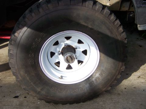 1991 Ford Bronco - A close-up view of a Dunlop Mud Rover tire mounted on a white 5-lug wheel.