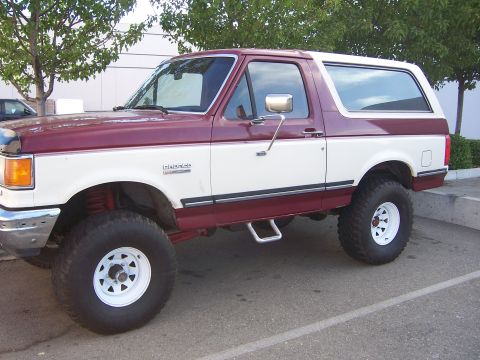 1991 Ford Bronco - This lifted 1991 Ford Bronco is shown in a two-tone maroon and white paint scheme.