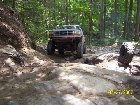 1978 Ford Bronco - Off-roading in a modified Ford Bronco on a challenging rocky path.