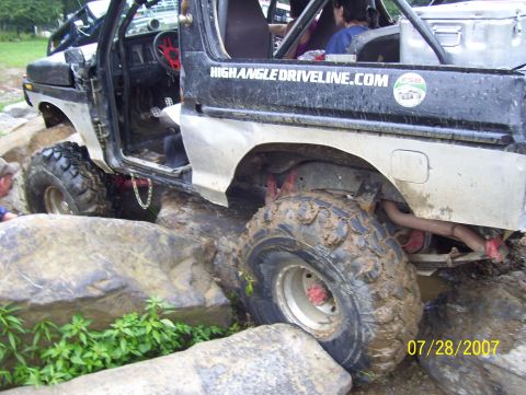 1978 Ford Bronco - This 1978 Ford Bronco is navigating a rocky obstacle course with its driver's door open.