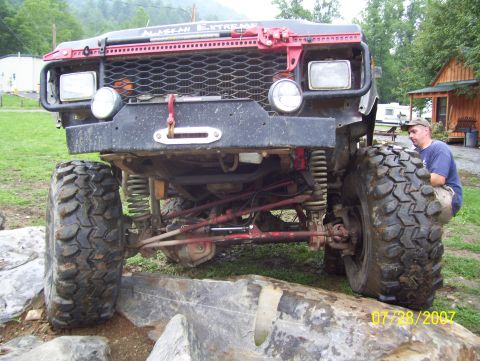 1978 Ford Bronco - A heavily modified off-road vehicle is positioned on rocks, with a man observing its front end. The date 07/28/2007 is visible.