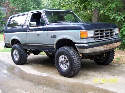 1979 Ford F-150 - This Ford Bronco has a two-tone paint scheme and is lifted with large off-road tires.