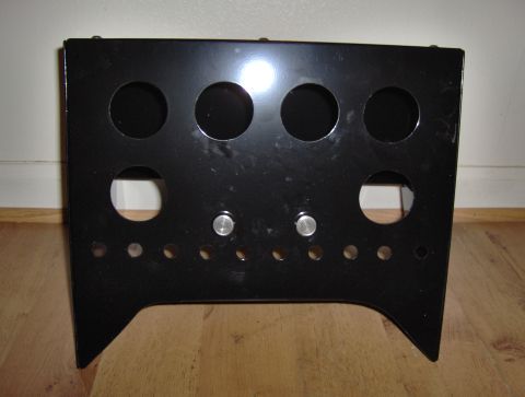 1978 Ford Bronco - This black metal console part features multiple circular cutouts and two silver knobs, likely for accessory mounting.