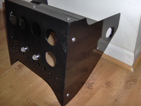 1978 Ford Bronco - A black metal console with various circular openings is shown from an angled perspective.