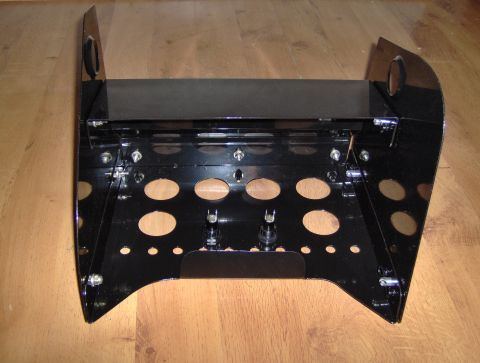 1978 Ford Bronco - Black metal bracket with numerous cutouts, possibly for a vehicle's center console components.